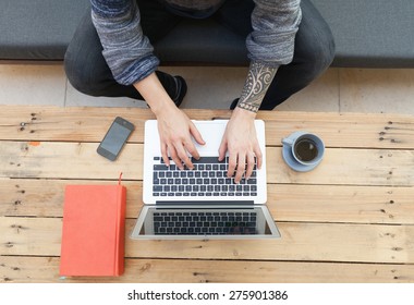 Hipster Guy Using His Laptop Outdoors And Relaxing