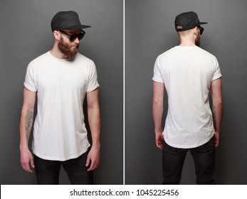Hipster handsome male model with beard wearing white blank t-shirt with space for your logo or design over gray background