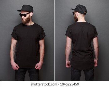 Hipster handsome male model with beard wearing black blank t-shirt with space for your logo or design over gray background - Shutterstock ID 1045225459