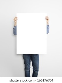 Hipster Holding Poster On Concrete Wall