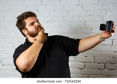 hipster image. a man use camera for taking himself. male photographer taking a picture with camera.