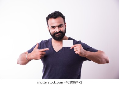 Hipster Indian/Asian Young Man With Beard And Moustache Displaying Blank Empty White Business Card