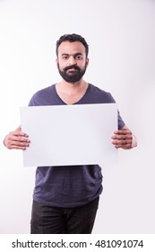 Hipster Indian/Asian Young Man With Beard And Moustache Displaying Blank Empty White Business Card