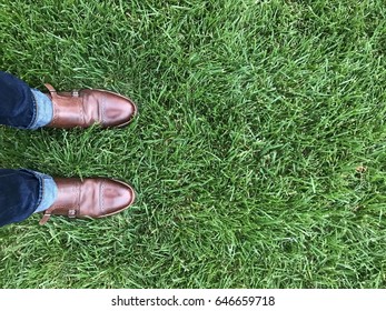 Hipster Leather Monk Strap Shoes And Cuffed Jeans On Grass