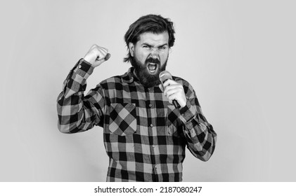 Hipster With Long Hair And Moustache Sing Song. Male In Karaoke. Music And Vocal Concept. Bearded Man In Checkered Shirt With Microphone. Casual Guy Country Music Singer