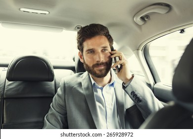 Hipster Man In Car On Mobile Phone. Filter Vintage