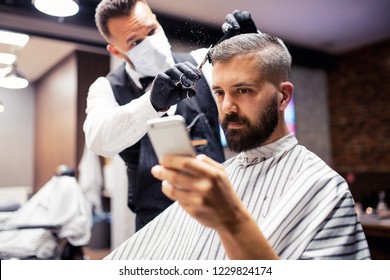 Hipster man client visiting haidresser and hairstylist in barber shop, taking selfie. - Powered by Shutterstock