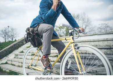 Hipster Man With A Fixie Bike And Smartphone In A Park Outdoors