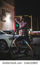 Hipster Man On Scooter In Night