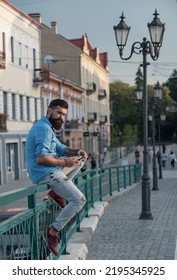 Hipster Man Texting On The Mobile Phone.