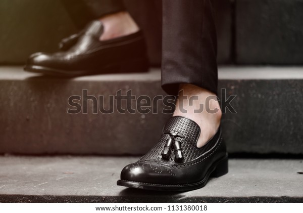 Hipster man wear fashion shoes tassel
loafer.On old  floor. Stylish men shoes
concept.