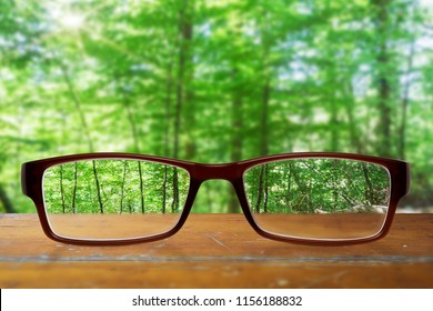 hipster modern glasses on a table with a forest in the background - Shutterstock ID 1156188832