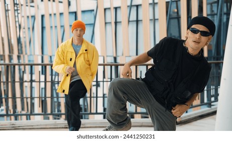 Hipster perform break dancing while partner dancing together at corridor, modern mall. Hip-hop music dancer practice footstep and move to music. Outdoor sport 2024. Active, energetic dance. Endeavor. - Powered by Shutterstock