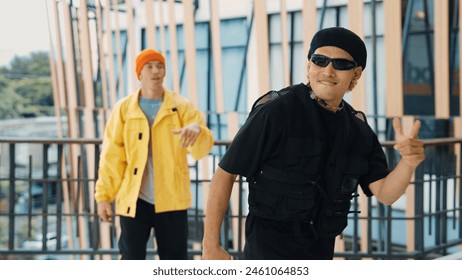 Hipster perform break dancing while partner dancing together at corridor, modern mall. Hip-hop music dancer practice footstep and move to music. Outdoor sport 2024. Active, energetic dance. Endeavor. - Powered by Shutterstock