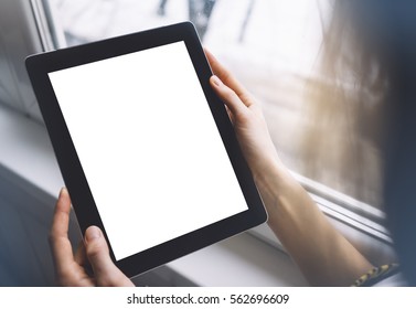 Hipster Person Hands Holding Digital Tablet With Empty Blank Screen, Against A Background Of  Window Horizontal,  Freelancer Girl Using At Home On A Computer On The Balcony, Mockup Teghnology,  Blur