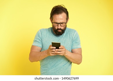 Hipster puzzled use smartphone. Man inexperienced user of modern smartphone. Stay in touch with smartphone. Join online community. User friendly concept. Man puzzled mobile phone opportunities. - Shutterstock ID 1490627699