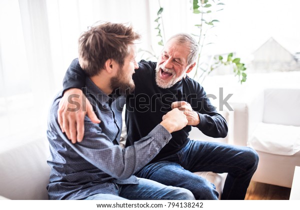 Hipster son with his senior father at home.