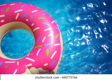 Hipster Sprinkled Donut Float In Sunny Pool Background Straight Down On Bright Clear Pool Water