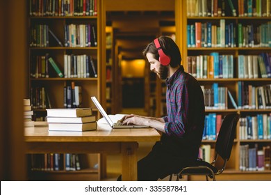 Hipster Student Studying In Library At The University