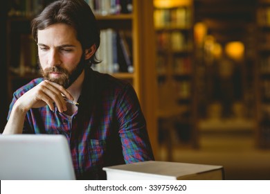 Hipster Student Studying In Library At The University