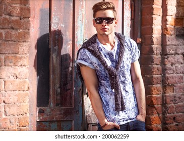 Hipster Style Guy. Fashion Man Standing Near A Wooden Door