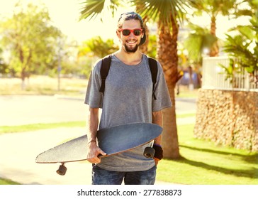 Hipster style guy. Fashion man on street palm at sunset