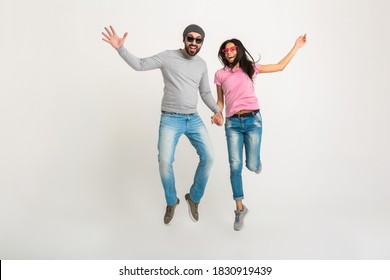 hipster stylish couple jumping isolated on white background, pretty smiling emotional woman and man dressed in jeans, active and positive, having fun together - Shutterstock ID 1830919439