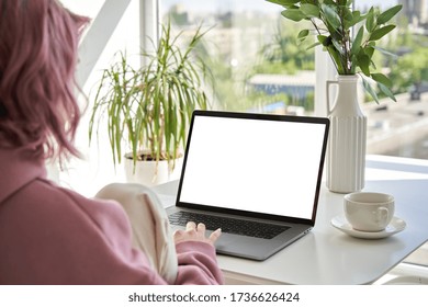 Hipster Teen Girl Student Sit At Kitchen Table Using Laptop Computer Touchpad Mock Up White Blank Monitor Screen Learning Online On Modern Notebook Working From Home Office. Over Shoulder Closeup View