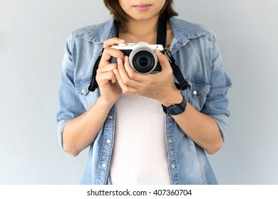 hipster traveler photographer girl taking picture on vintage camera, [blur and select focus background]  - Powered by Shutterstock