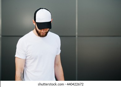Hipster wearing white blank t-shirt and a cap with space for your logo 