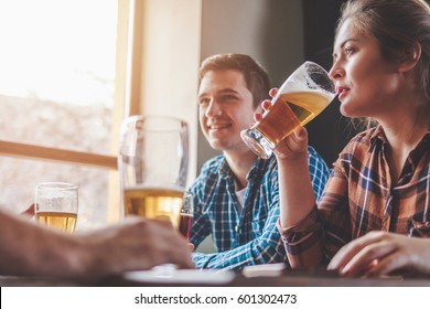 Hipster Woman Drinking Beer With Friends At Bar Or Pub