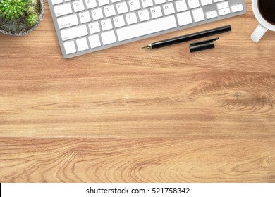 Hipster Wood Office Desk Table With Computer Keyboard, Pen And Coffee Cup. Top View With Copy Space, Flat Lay.