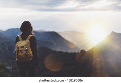 Hipster young girl with backpack enjoying sunset on peak of foggy mountain. Tourist traveler on background view mockup. Hiker looking sunlight in trip in Spain country, mock up text. Picos de Europa - Shutterstock ID 458190886