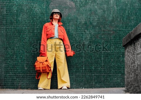 Similar – Image, Stock Photo Stylish fashion girl with cool hairstyle and blue shirt showing heart with fingers on yellow background