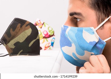 Hipsterman With Fashion Protective Mask. Man Choosing Face Mask Against Coronavirus.  New Normal. Modern Homemade Face Masks Full Color Mask. Covid. Social Distancing In Covid-19