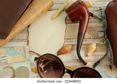 Hipster's fashion accessories - notebook, wallet, pen, smoking pipe, eyeglasses, case for eyeglasses, sunglasses, money and empty paper for copy space - Powered by Shutterstock