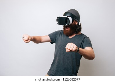 Hipster,young Bearded Man With Excited Face Driving Bike On High Speed In Virtual Reality With Modern Digital Gadget. Virtual Driving Lessons Concept.