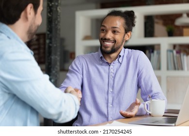 Hired African employee shake hand recruitment manager completing successful job interview in office. Two business people greet each other, start formal meeting. Gesture of respect, make a deal concept - Shutterstock ID 2170254245