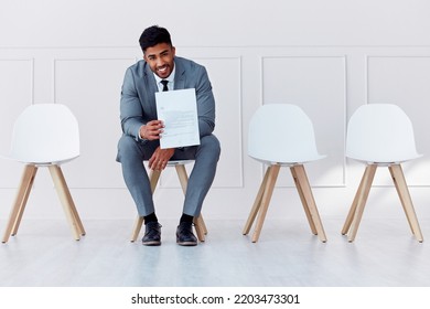 Hiring, recruitment and business man in a waiting room for a corporate company job interview. Happy, smile and confident career businessman with professional cv ready for job, interview or recruiting - Shutterstock ID 2203473301