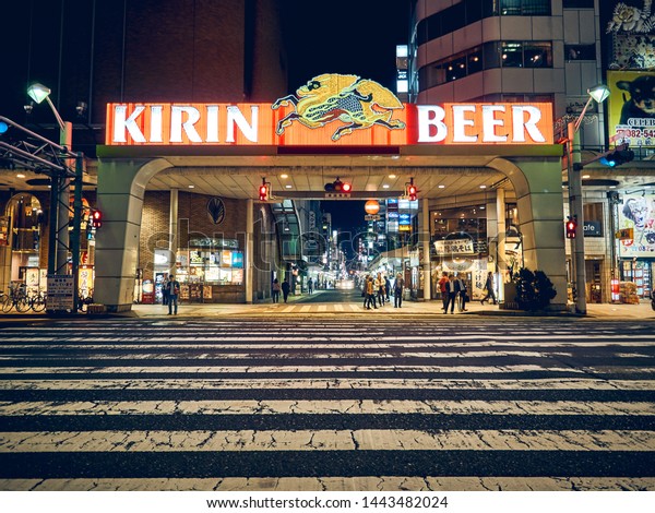 Hiroshima, Japan - April 30\
2015: Image taken of one of the many large and wider zebra crossing\
in Japan leading into the town shopping centre over a large Kirin\
Beer logo.