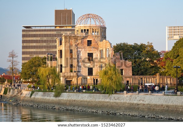 HIROSHIMA, JAPAN – NOVEMBER 23, 2007: Sunset\
view of the Atomic Bomb Dome, the skeletal ruins of the former\
Hiroshima Prefectural Industrial Promotion Hall on the rivershore\
of Ota river.\
Hiroshima
