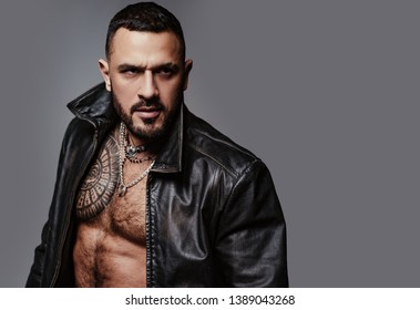 In His Brutal Style. Brutal Hispanic Man. Bearded Latino Man With Brutal Tattoo On Muscular Chest. Brutal And Athletic, Copy Space.