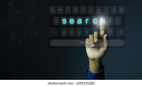 His Hand Reached Up To Press The Keyboard  To Searching For The Information On The Internet With The Word Search Icon Appearing On The Virtual Keyboard.