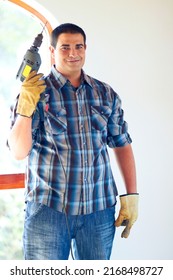 His Middle Name Is Handy. Shot Of An Attractive Male Handyman With Drill.