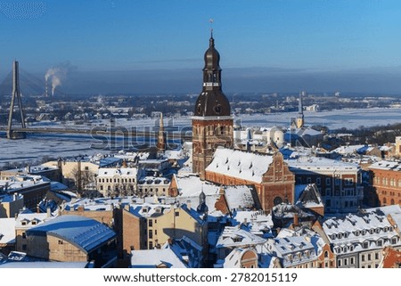 his panoramic image captures a winter view of Riga, the capital of Latvia. In the centre stands Riga Dome Cathedral , recognisable by its distinctive large spire and massive scale as the largest medieval church in the Baltic states