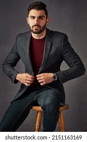 His Style Always Leaves A Lasting Impression. Studio Portrait Of A Handsome Young Man Posing Against A Dark Background.