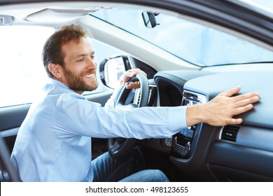 His True Love. Portrait Of A Mature Man Smiling Happily Sitting In A Brand New Car Touching The Dashboard 