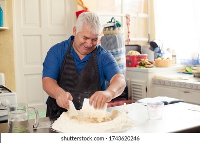 Hispanic Adult Man Preparing Bread Dough - Grandfather Cooking At Home - Man With Gray Hair Making Artisan Bread