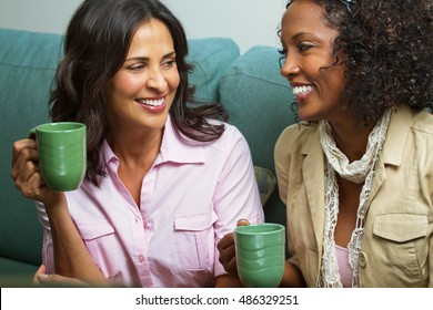 Hispanic and African American Woman talking and drinking coffee - Powered by Shutterstock