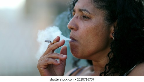 Hispanic Anxious Woman Smoking Cigarette.